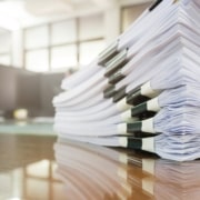 A stack of documents signifying the new registration requirements