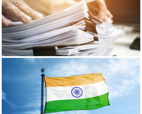 A picture of a stack of documents on top of an image of the flag of India
